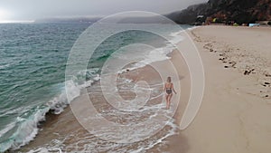 Relaxing summer holiday at the beach - cute girl at the ocean