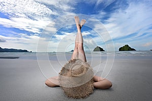 Relaxing in summer holiday. Woman lay down on the beach and rise her lags up