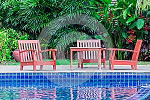 Relaxing Table set beside swimming pool.