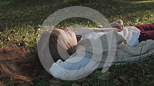 Relaxing teenager girl resting on the grass