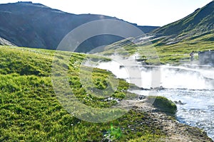 Relaxing time in the hot spring thermal river in a valley of Iceland