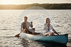 Relaxing on the water. a young couple rowing a boat out on the lake.