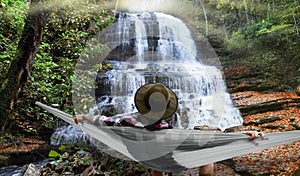 Man relaxing by a waterfall photo