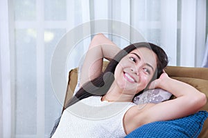 Relaxing woman lie down comfortable and smiling happy at home.