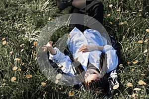 Relaxing woman lying on spring blooming meadow. Girl resting in spring park. Enjoy life
