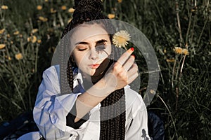 Relaxing woman lying on spring blooming meadow. Girl resting in spring park. Enjoy life