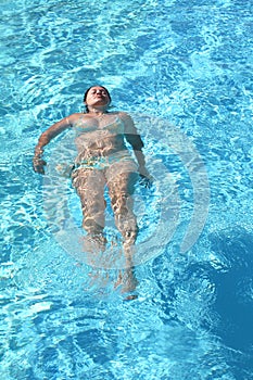 Relaxing woman in swimming pool