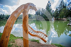 Relaxing wooden swing over Lake Bloke at Nova Vas in Slovenia