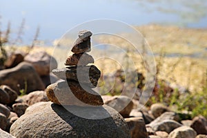 Relaxing, Zen Like View Including Stacks of Natural Rocks and a Lake during a Sunny Day
