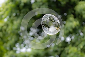 Releasing huge colorful soap bubbles in the open air