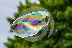 Releasing huge colorful soap bubbles in the open air