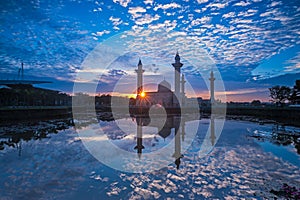 Relfection of a Mosque and Clouds at sunrise