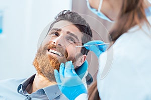 Reliable dentist using sterile instruments while cleaning the te