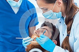 Reliable dentist using sterile instruments while cleaning teeth