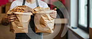 Reliable service Hands of a smiling deliveryman holding food containers