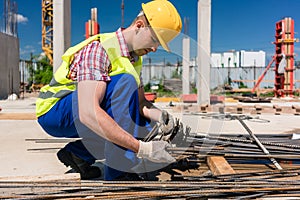 Reliable worker checking the quality of the steel bars