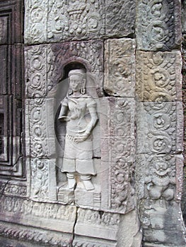 Relief carvings on stone walls of ancient sacred temple in the city of Ankgor Wat