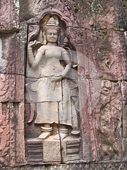 Relief carvings on stone walls of ancient sacred temple in the city of Ankgor Wat