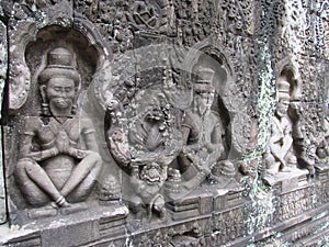 Relief carvings on stone walls of ancient sacred temple in the city of Ankgor Wat