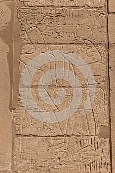 Relief details and Egyptian hieroglyphs at Karnak temple complex in Luxor