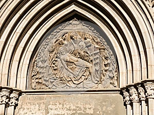 Relief of the Door of piety. Cathedral Of The Holy Cross And Saint Eulalia In Barcelona, Catalonia. Spain