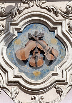 Relief on facade of old building, House Under three violins, Neruda street, Prague, Czech Republic, Europe