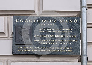 A relief and informational plaque honoring Kogutowicz Mano, a famous Hungarian cartographer