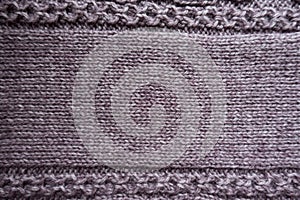 Relief pattern on edges of puce stocking stitch fabric photo