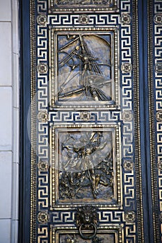 Relief panels with the history of Cuba on the front door, close-up. National Capitol Building