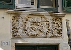 Relief of Saint George slaying the dragon above a door in Genoa, Italy