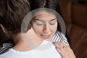 Relieved happy woman hugging man, thanking for support, close up photo