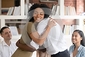 Diverse people hug show empathy at group counselling photo