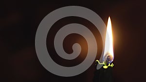 Religion, Christianity, Orthodoxy, holidays, cult concept - One single burning green candle against background of icon