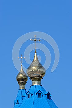 Blue roofs of russian orthodox church against clear blue sky. Cathedral of Our Lady of Kazan in Komsomolsk-on-Amur in Russia photo
