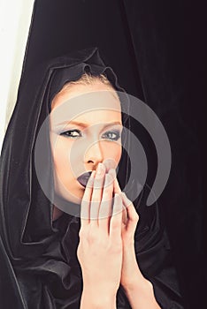 Religion and death concept. madonna woman in black hood. Makeup look and skincare sensual of girl. Fashion model