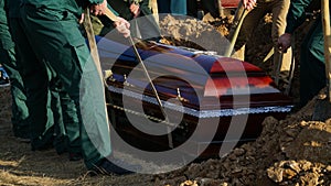 Religion, death and dolor - coffin bearer carrying casket at funeral to cemetery photo