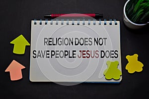 Religion Does Not Save People Jesus Does write on a book  on office desk. Christian faith concept