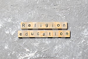 Religion education word written on wood block. religion education text on cement table for your desing, concept