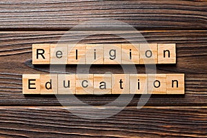 Religion education word written on wood block. religion education text on wooden table for your desing, concept