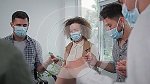 religion, group of young men and women in medical masks hold their friends hands and with closed eyes pray to God with