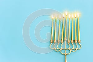 Religion image of jewish holiday Hanukkah background with menorah (traditional candelabra) and candles. Top view