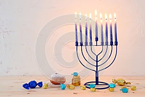 religion image of jewish holiday Hanukkah background with menorah & x28;traditional candelabra& x29;, spinning top and doughnut