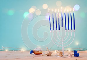 religion image of jewish holiday Hanukkah background with menorah & x28;traditional candelabra& x29;, spinning top and doughnut