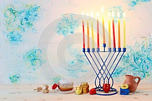 religion image of jewish holiday Hanukkah background with menorah & x28;traditional candelabra& x29;, spinning top and doughnut