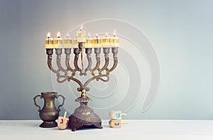 Religion image of jewish holiday Hanukkah background with menorah (traditional candelabra) and spinning top toy