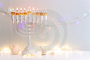 Religion image of jewish holiday Hanukkah background with menorah (traditional candelabra) and spinning top toy