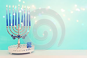 Religion image of jewish holiday Hanukkah background with menorah (traditional candelabra) and spinning top toy