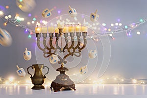 Religion image of jewish holiday Hanukkah background with menorah (traditional candelabra) and spinning top toy