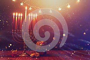 Religion image of jewish holiday Hanukkah background with menorah (traditional candelabra) and spinning top toy