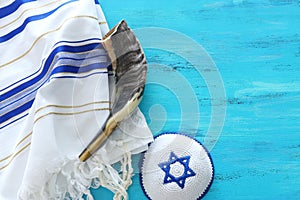 Religion image of shofar horn on white prayer talit. Rosh hashanah jewish New Year holiday, Shabbat and Yom kippur concept